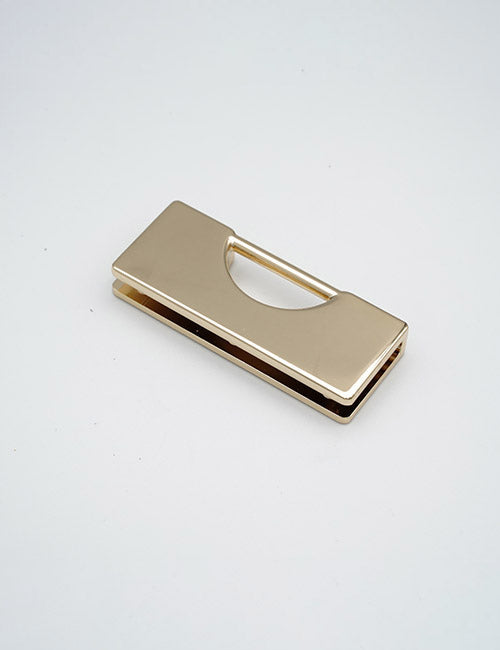 A rectangular, gold-colored YIPAI Handles money clip with a cut-out semicircle on one side is displayed on a plain white surface.