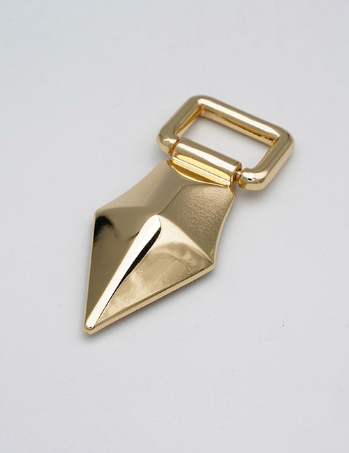 A shiny gold YIPAI Handle with a geometric metal design features a rounded rectangular grip and an angular, pointed base, displayed on a plain light gray surface.