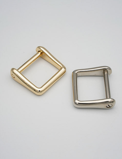 Two YIPAI Rings & Slides metal square buckles are displayed on a plain background; one is gold, the other silver. Both feature a simple, modern design with a removable bar.