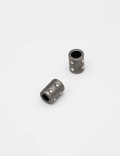 Two small, cylindrical dark-colored Handles by YIPAI, each embedded with multiple clear rhinestones, displayed on a plain white background.