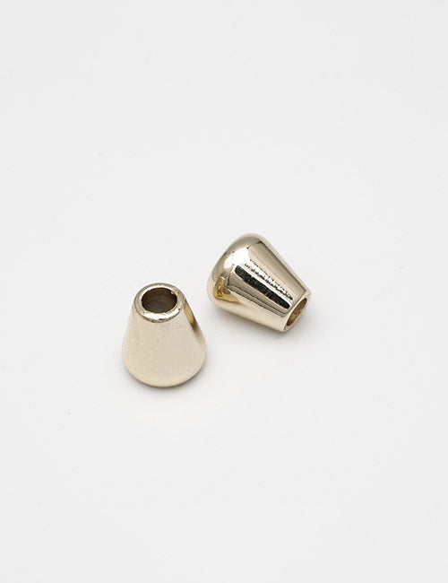 Two small, shiny, gold-colored cone-shaped YIPAI Handles are on a plain white background—one stands upright while the other lies on its side.