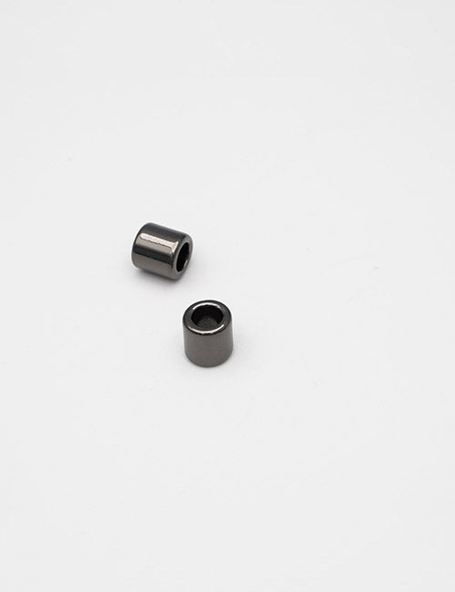 Two small, cylindrical YIPAI Handles with hollow centers are placed on a plain white background—one stands upright while the other lies on its side.