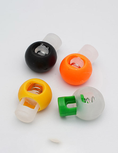 Four YIPAI Handles, each round and plastic with visible metal springs inside, come in black, orange, yellow, and white with a green button. They are arranged on a white background.