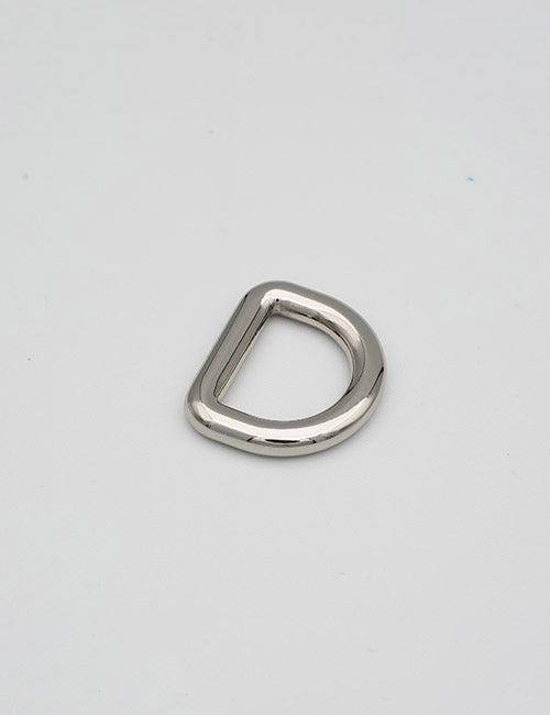A single YIPAI Rings & Slides silver metal D-ring lies flat on a plain light gray surface.