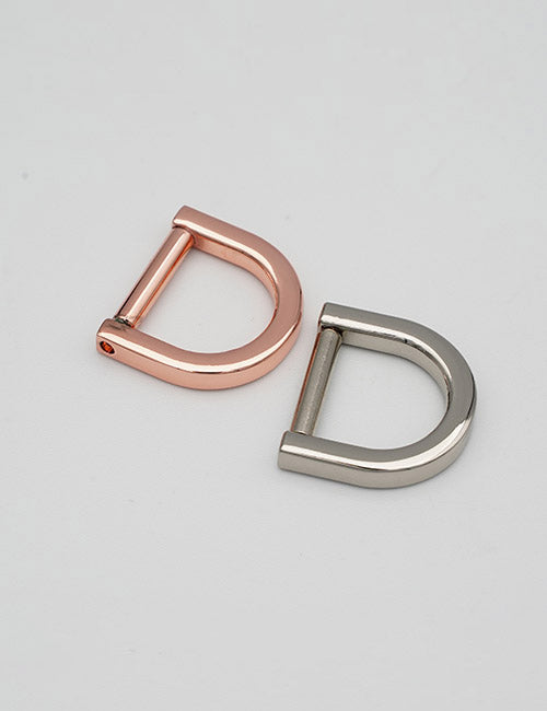 Two metal D-rings from YIPAI’s Rings & Slides collection—one rose gold, one silver—are displayed side by side on a light gray background.