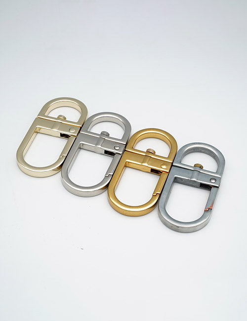 Four oval-shaped Rings & Slides by YIPAI in gold and silver finishes are arranged side by side on a white background.