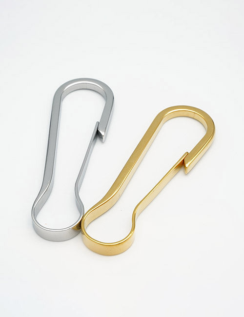 Two minimalist YIPAI Rings & Slides metal carabiners, one silver and one gold, are displayed side by side on a white background. Both have a sleek design without locking mechanisms.