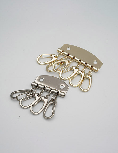 Two YIPAI Rings &Slides metal key holder hooks—one gold, one silver—each with three key clips, are displayed on a plain white background.