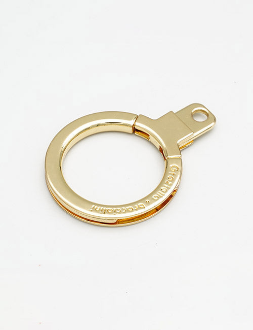 The YIPAI Rings & Slides is a gold circular metal keyring with a flat tab and small attachment hole, shown on a plain white background.