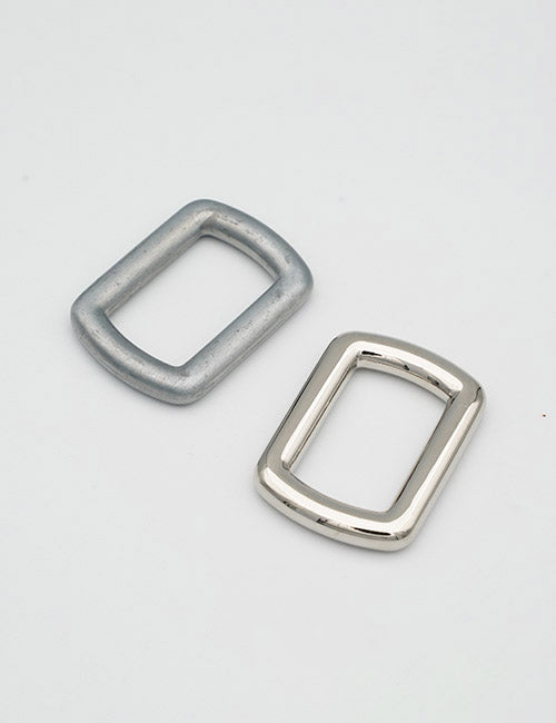 Two rectangular metal loops from YIPAIs Rings & Slides collection—one matte silver, one shiny chrome—are displayed side by side on a plain white background.