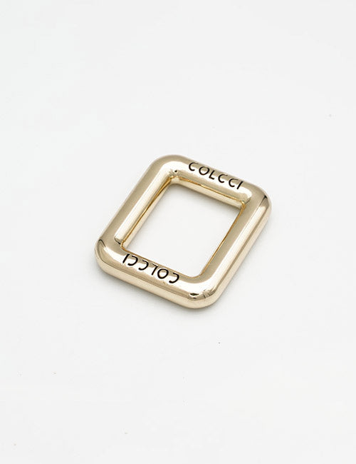A gold square-shaped metal buckle with rounded edges from YIPAIs Rings & Slides collection, engraved with COLCCI on two sides, displayed on a plain white background.