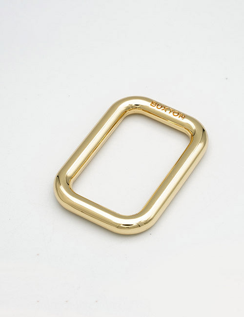 A shiny, gold, rectangular metal ring with rounded edges from YIPAI’s Rings & Slides collection, engraved with BURTON on one side, displayed against a white background.
