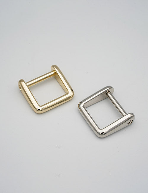 Two YIPAI Rings & Slides buckles—one gold, one silver—are placed side by side on a plain light gray background.