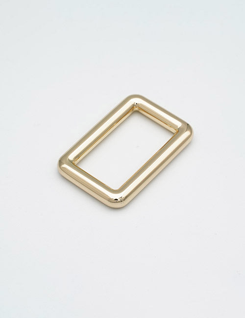 A shiny, gold-colored rectangular metal ring with rounded edges from YIPAIs Rings & Slides collection, displayed on a plain white background.