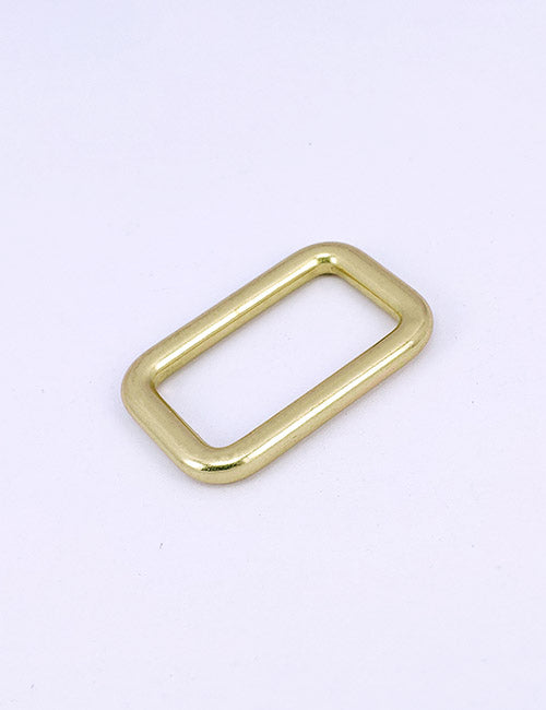 A small, gold-colored rectangular metal ring with rounded edges from YIPAIs Rings & Slides collection is displayed on a plain white background.