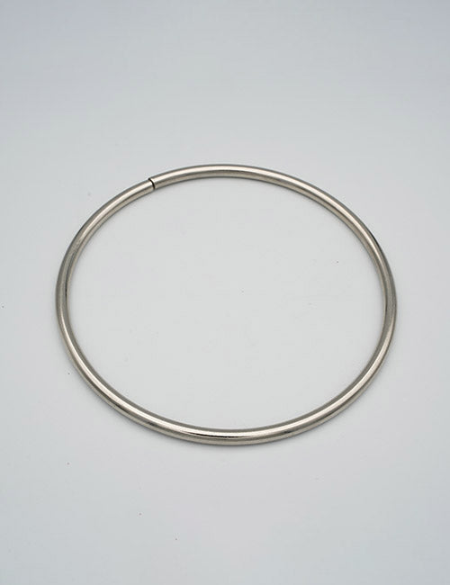 The YIPAI Rings &Slides is a simple metallic circular collar necklace with a smooth surface, showcased on a plain light gray background.