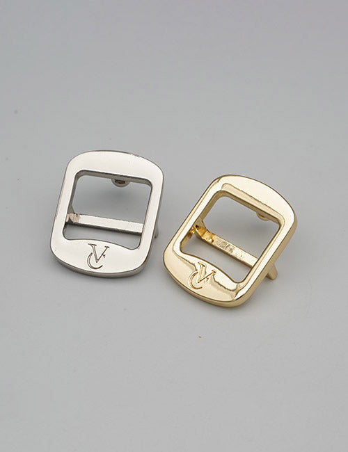 Two YIPAI Rings & Slides metal buckles, one silver and one gold, each engraved with a V on the lower edge, displayed on a plain gray background.