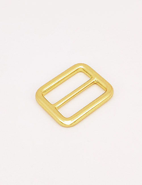 A rectangular gold-colored metal YIPAI Rings & Slides buckle with two parallel bars, shown on a plain white background.