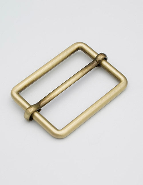 The YIPAI Rings & Slides is a rectangular, brass-colored metal belt buckle with a simple, minimalist design, shown on a plain white background.