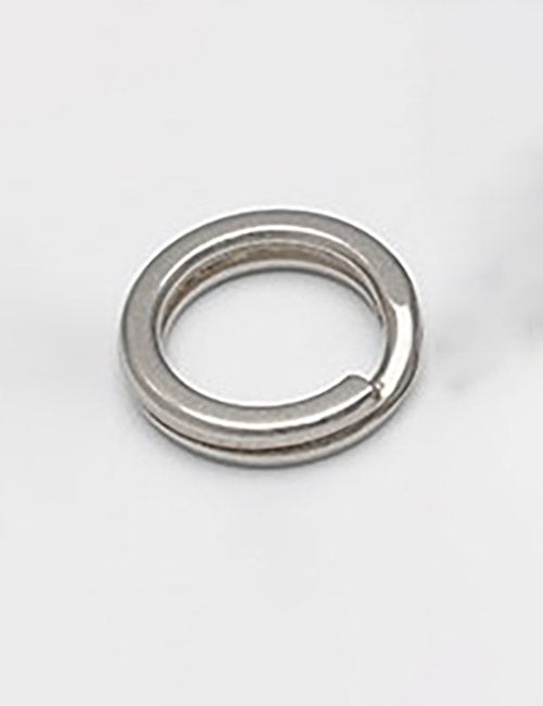 A close-up of the YIPAI Rings & Slides silver split key ring, showing its small gap as it lies flat on a white surface.