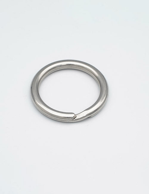 A YIPAI Rings & Slides silver metal keyring with a small gap, lying flat on a plain white background.