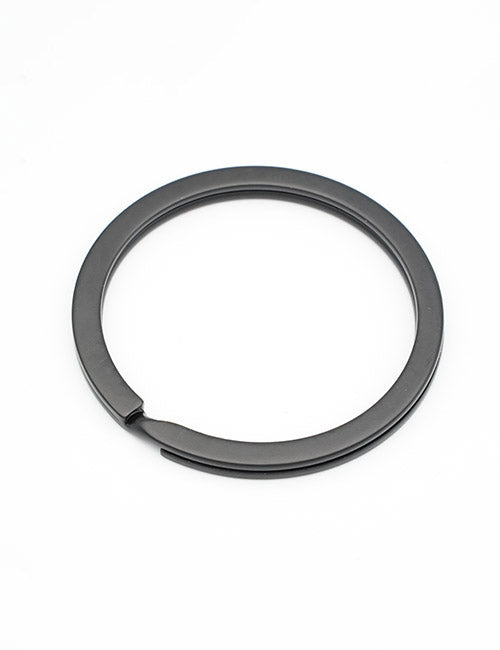 The YIPAI Rings & Slides is a black metal key ring with a small gap, shown lying flat on a white background.