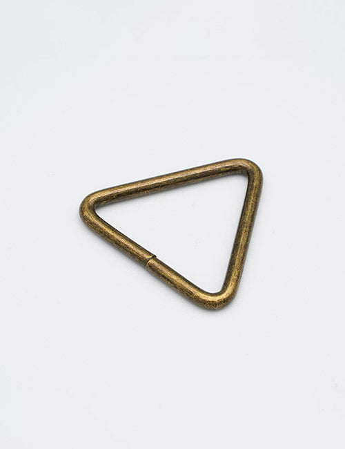 The YIPAI Rings & Slides is a small, brass-colored metal triangle with rounded edges and a slight opening on one side, displayed on a plain white background.