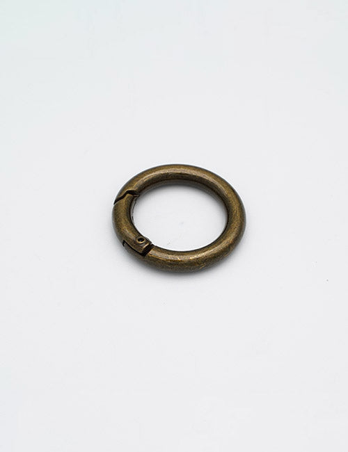 The YIPAI Rings & Slides is a single round brass-colored metal key ring with a small hinge and clasp, shown on a plain white background.