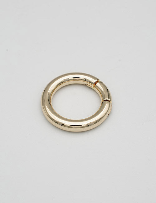The YIPAI Rings & Slides is a gold metal circular ring featuring a small hinge or opening, displayed flat on a plain light gray background.