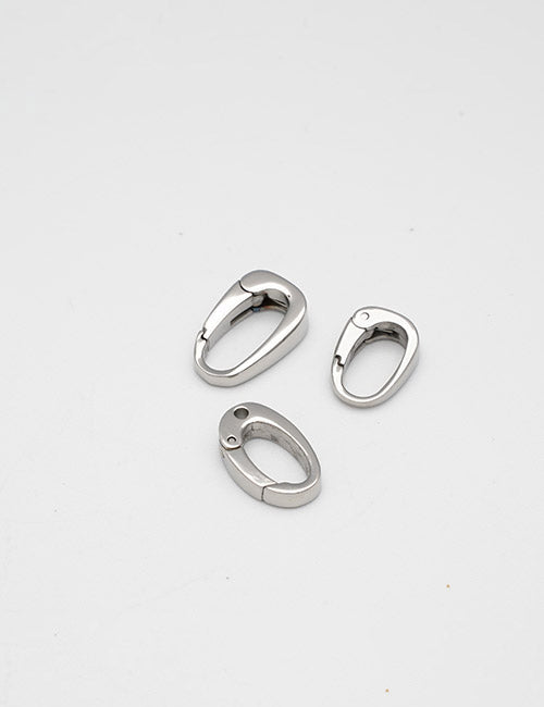 Three small, oval-shaped silver Rings & Slides by YIPAI are arranged on a plain white background.