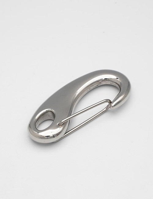 A YIPAI Snap Hook, featuring a shiny silver finish, smooth curved design, and spring-loaded gate, rests on a plain white surface.