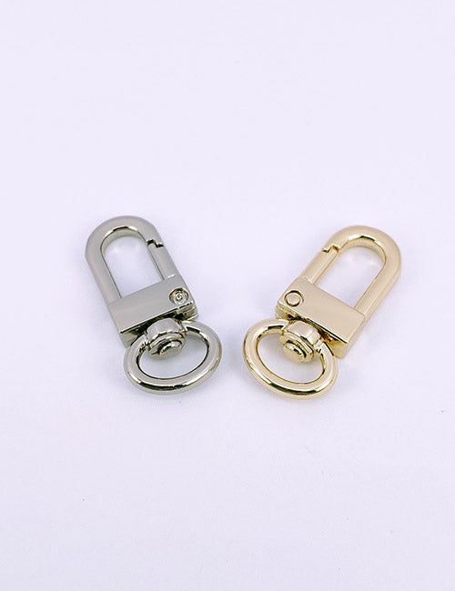 Two YIPAI Snap Hooks, one silver and one gold, are displayed side by side on a plain white background. Each hook features a rounded clasp and a circular ring at the bottom.