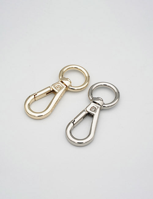 Two YIPAI Snap Hooks, one gold and one silver, lie side by side on a plain white background. Each features a round key ring attached to a spring-loaded clasp.
