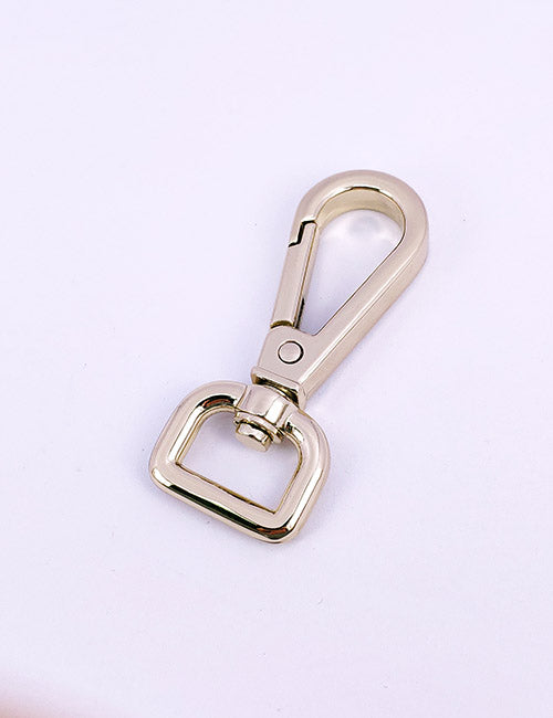 A YIPAI Snap Hook, featuring a shiny silver metal swivel clasp with a spring-loaded gate and rectangular base, is displayed on a plain light purple background.
