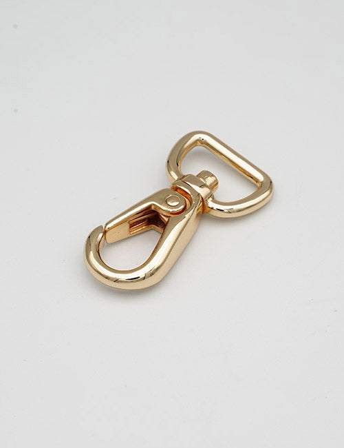 A YIPAI Snap Hook in shiny gold metal with a rectangular loop and swivel clasp rests on a plain white surface.
