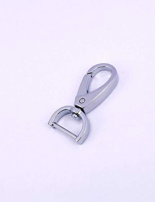 A YIPAI Snap Hook in silver metal, featuring a rounded top and D-shaped swivel base, is displayed on a plain light purple background.